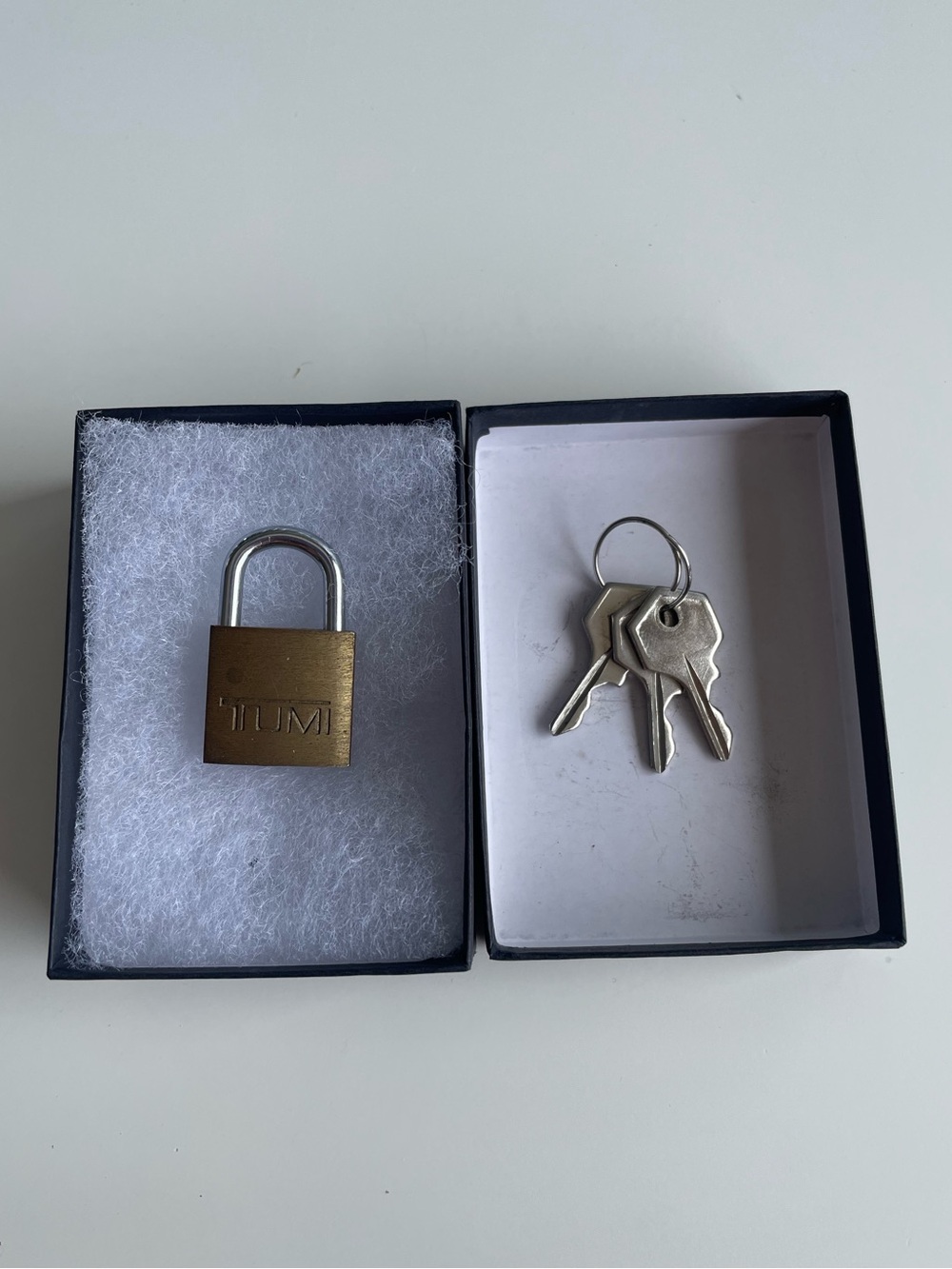 Authentic TUMI brass luggage padlock with matching keys included